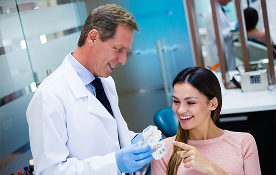 Dentist And Patient Discussing Treatment